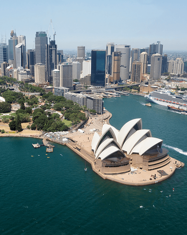 person in blue shirt writing on white paper
