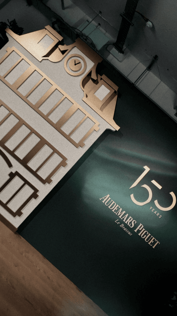 Woman hugging Shiba Inu dog in front of white fence