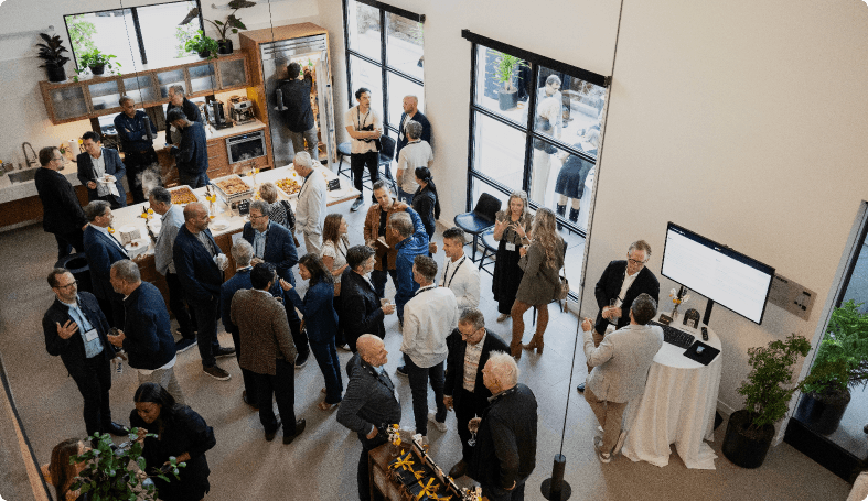 Three people sitting beside each other laughing.