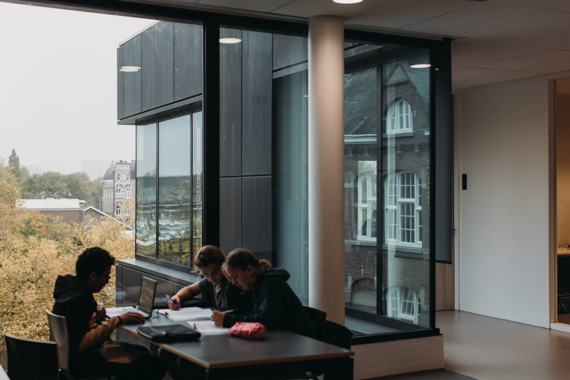 Interior photo of a concentration workspace where students are working in small groups