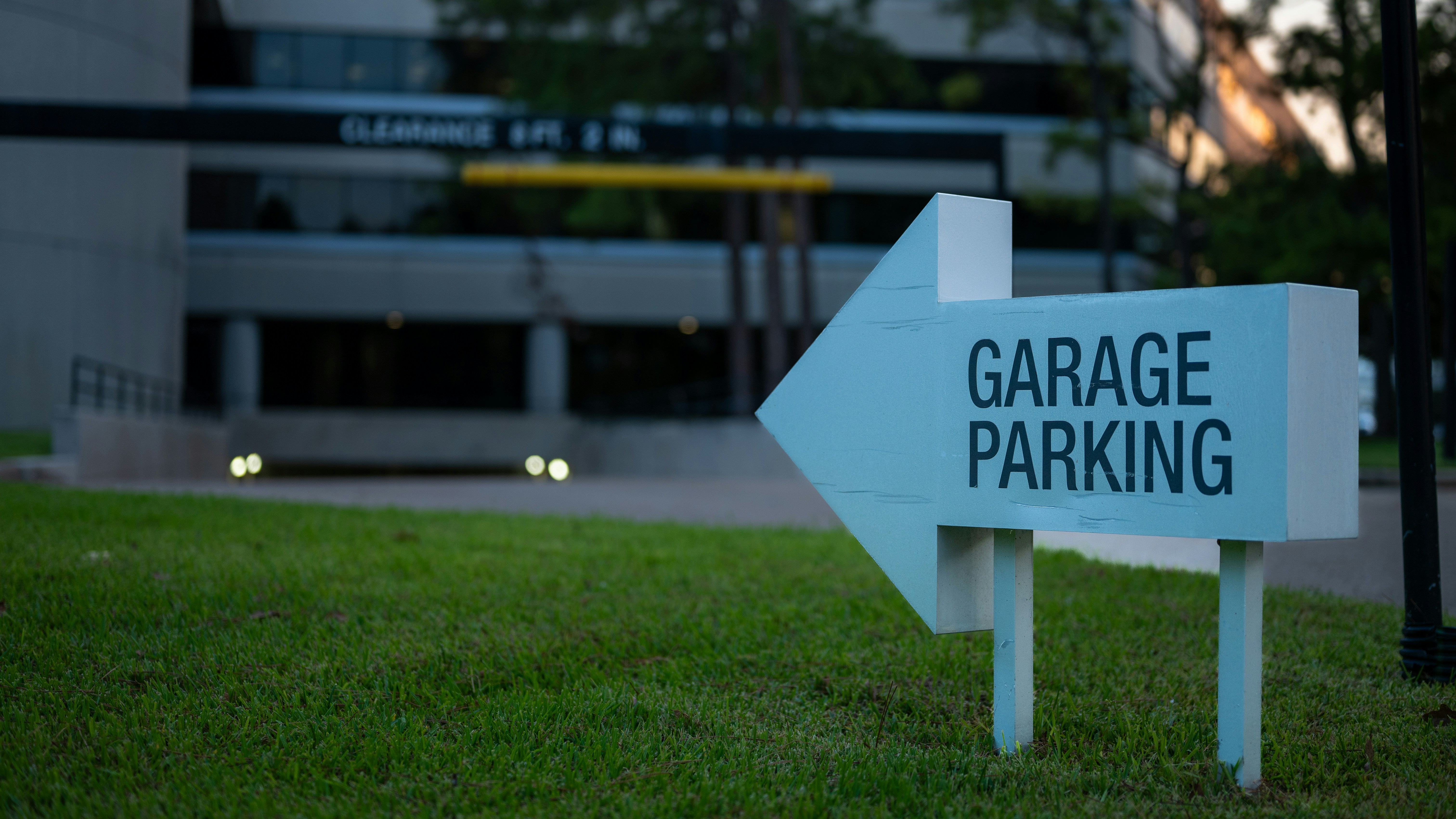 Garage parking sign with an arrow pointing toward a parking structure.