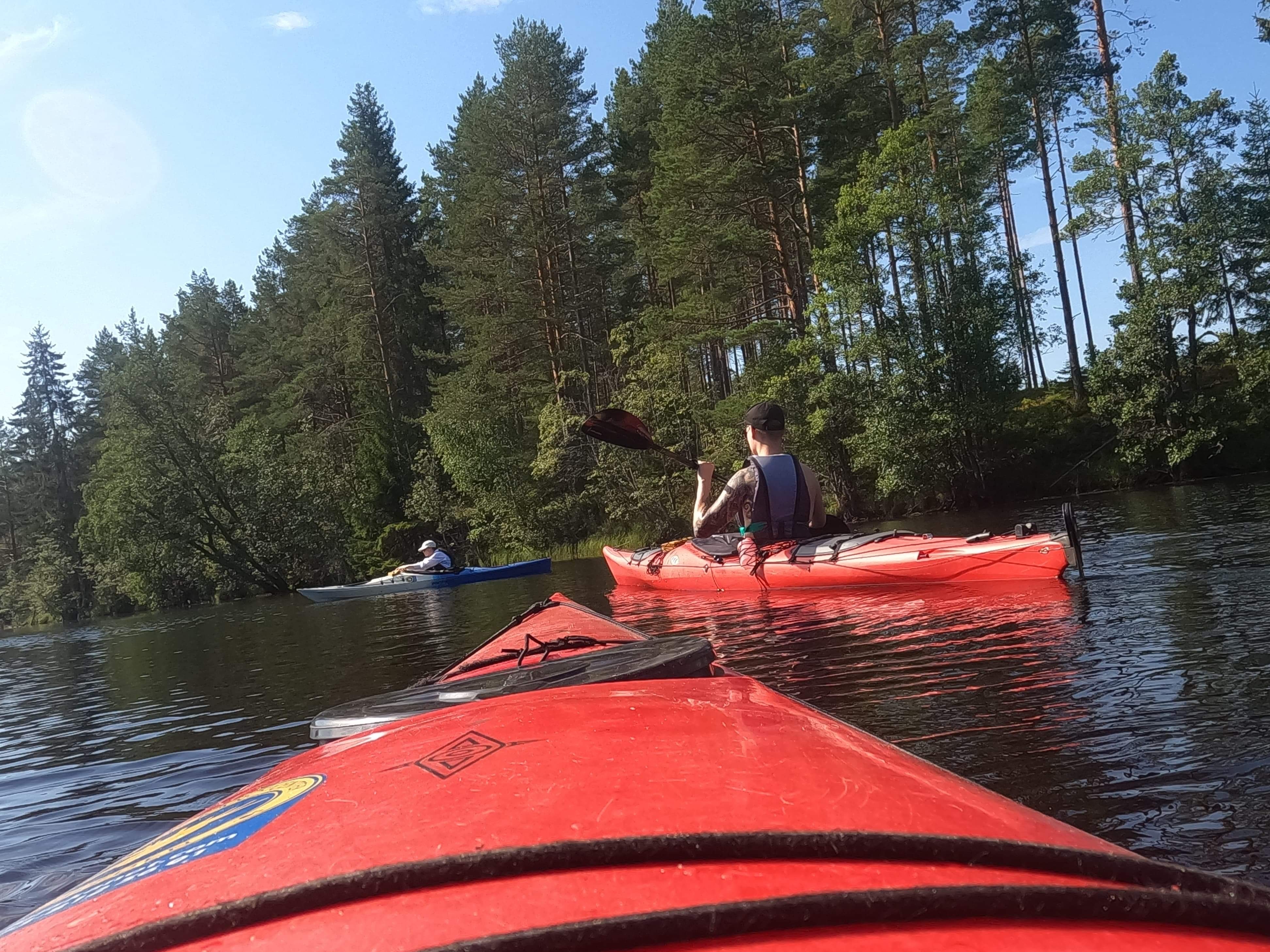 Joakim is sitting on the floor with his dog in his lap.
