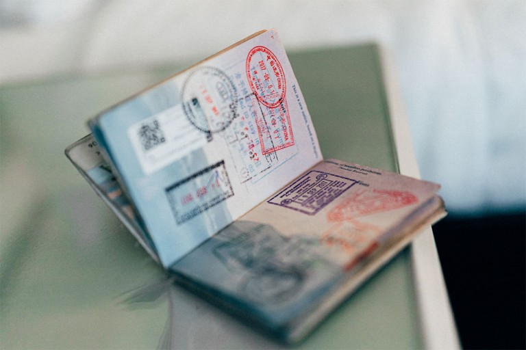 Open passport showing multiple entry and exit stamps.