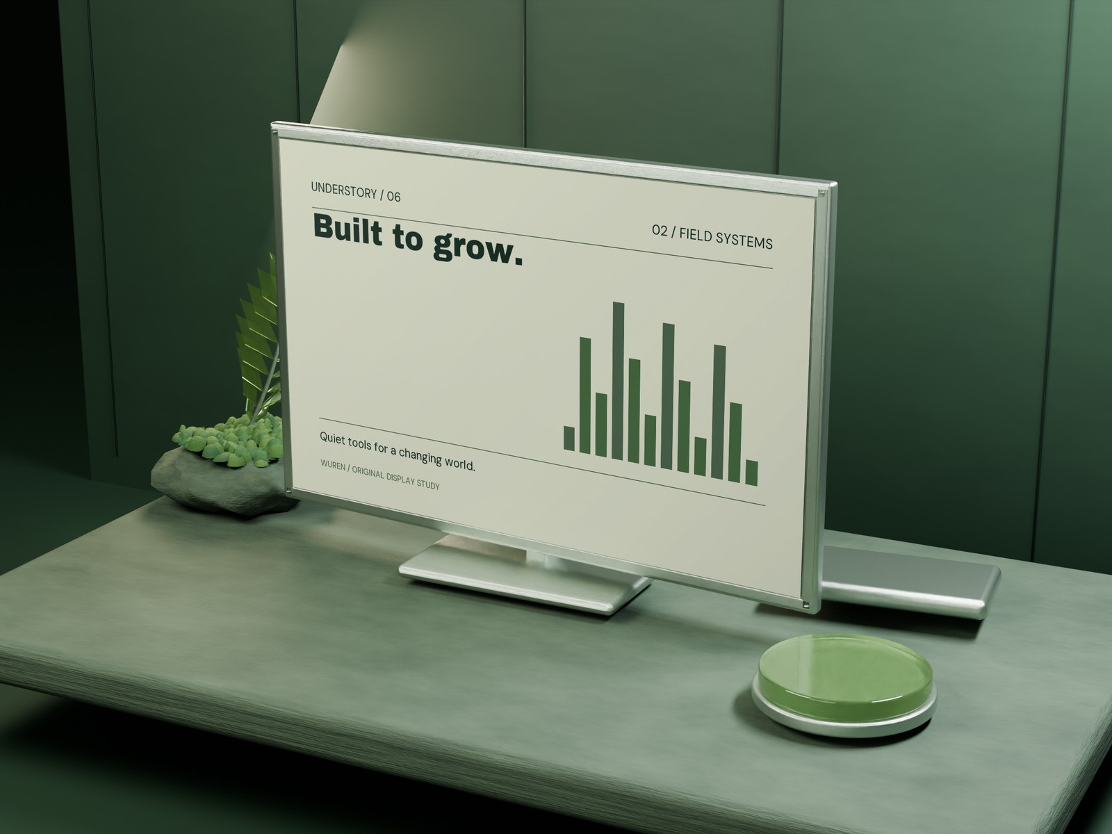 An original silver landscape screen with a cream and moss-green graphic design on a mineral desk.