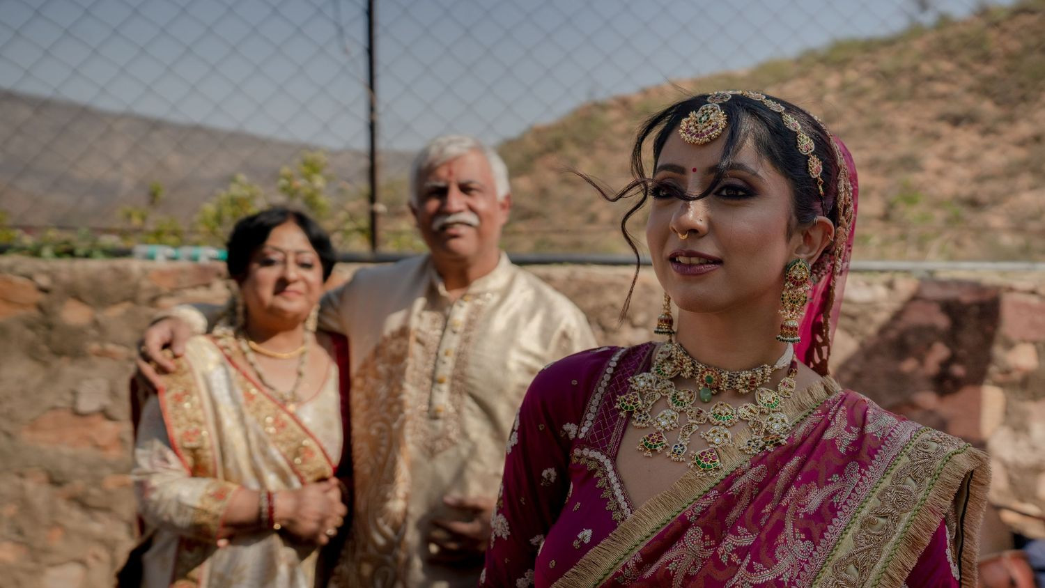 indian bride with parents outdoor wedding portrait family emotional moment