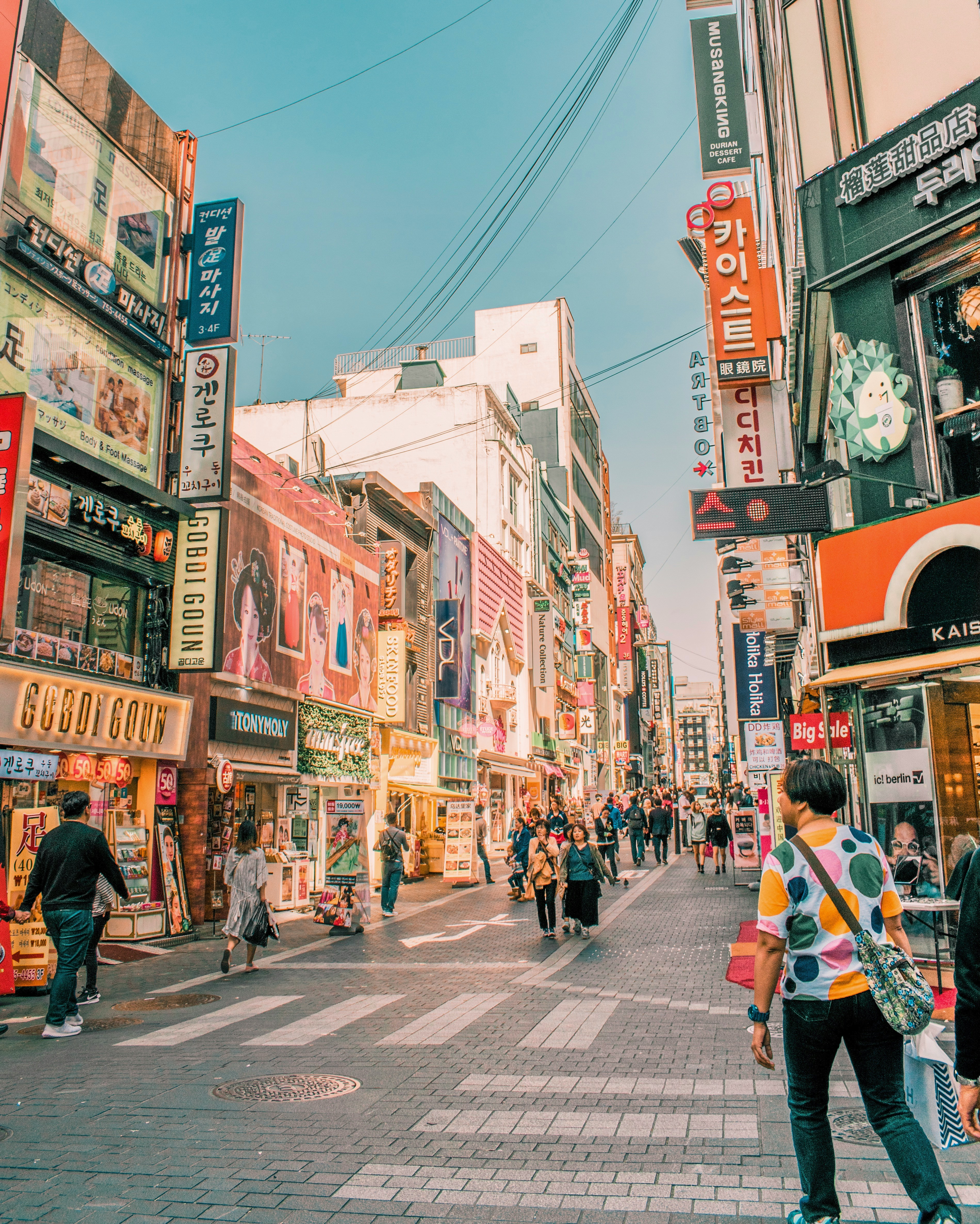 people walking on road surrounded by buildings