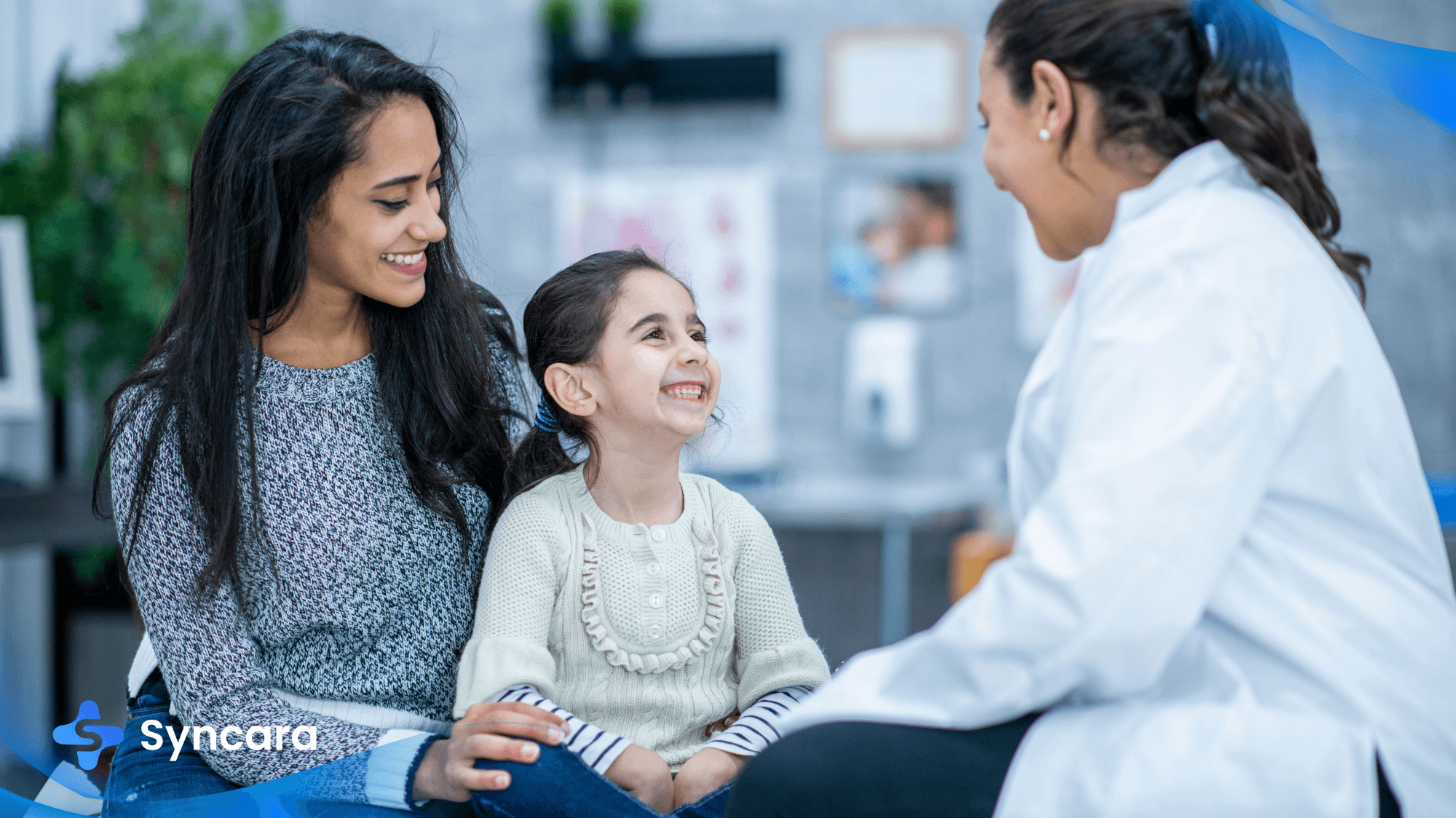 Family doctor in Oakville consulting with a mom and her daughter in a modern clinic