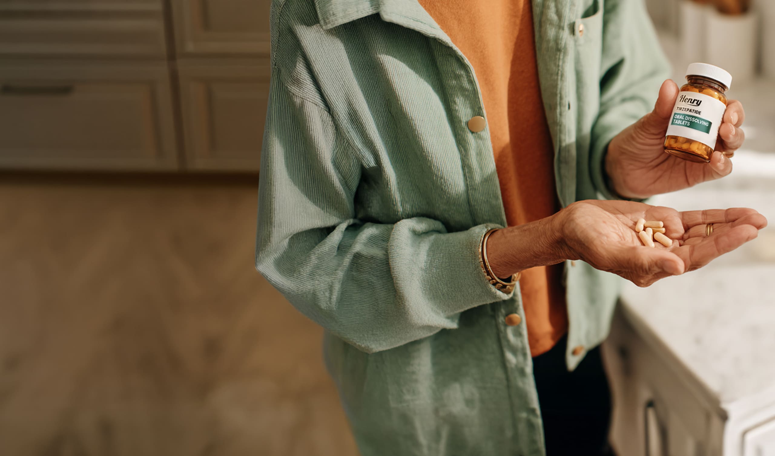 A person holding some weight loss pills