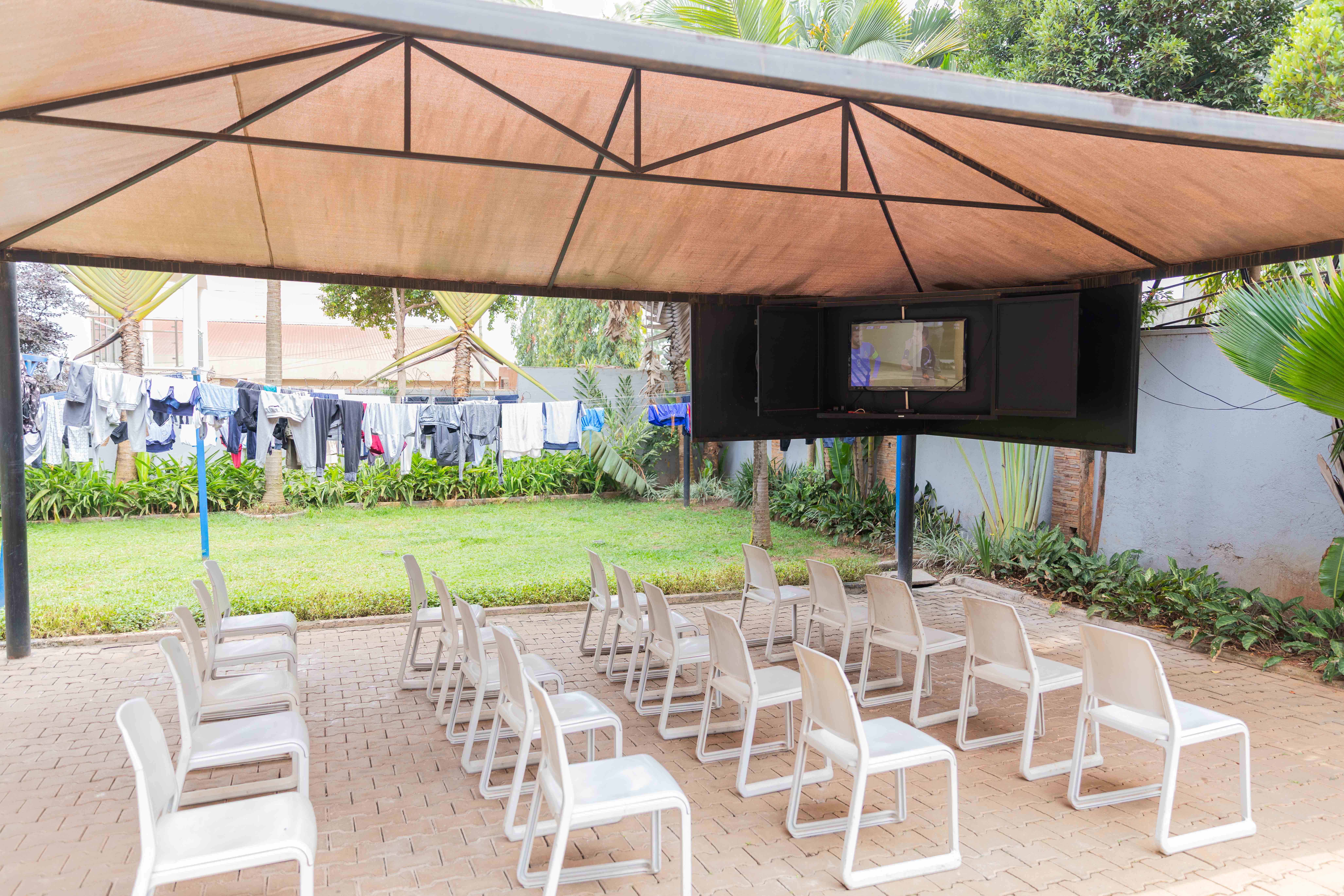 Two cheerful students are balancing books on their heads, smiling and laughing