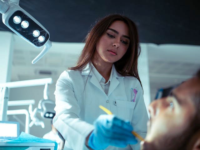 Dentist working with patient.