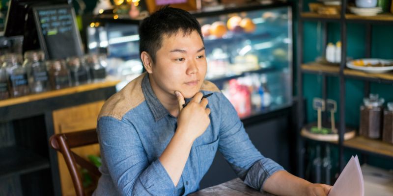 A male customer waiting for his food at a restaurant