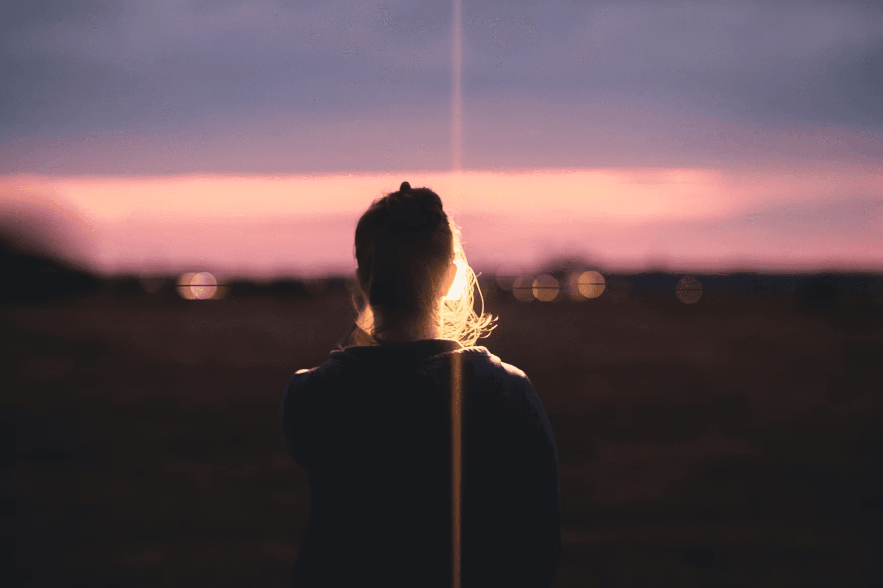 a person looking at the sunset