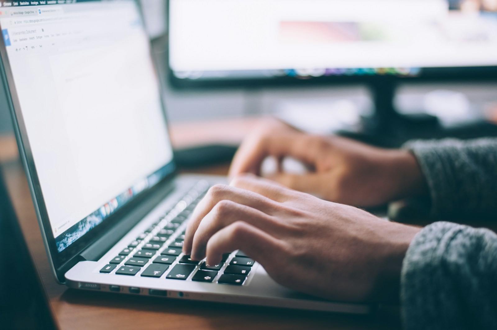 Hands using a laptop to customize a website