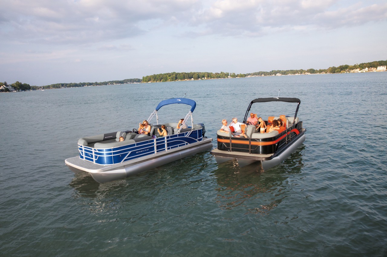 A pontoon and tritoon on the lake