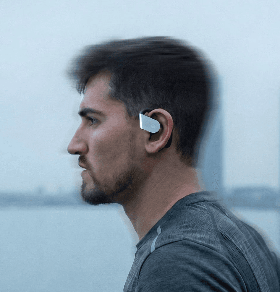 A person stands in a sandstone cave.