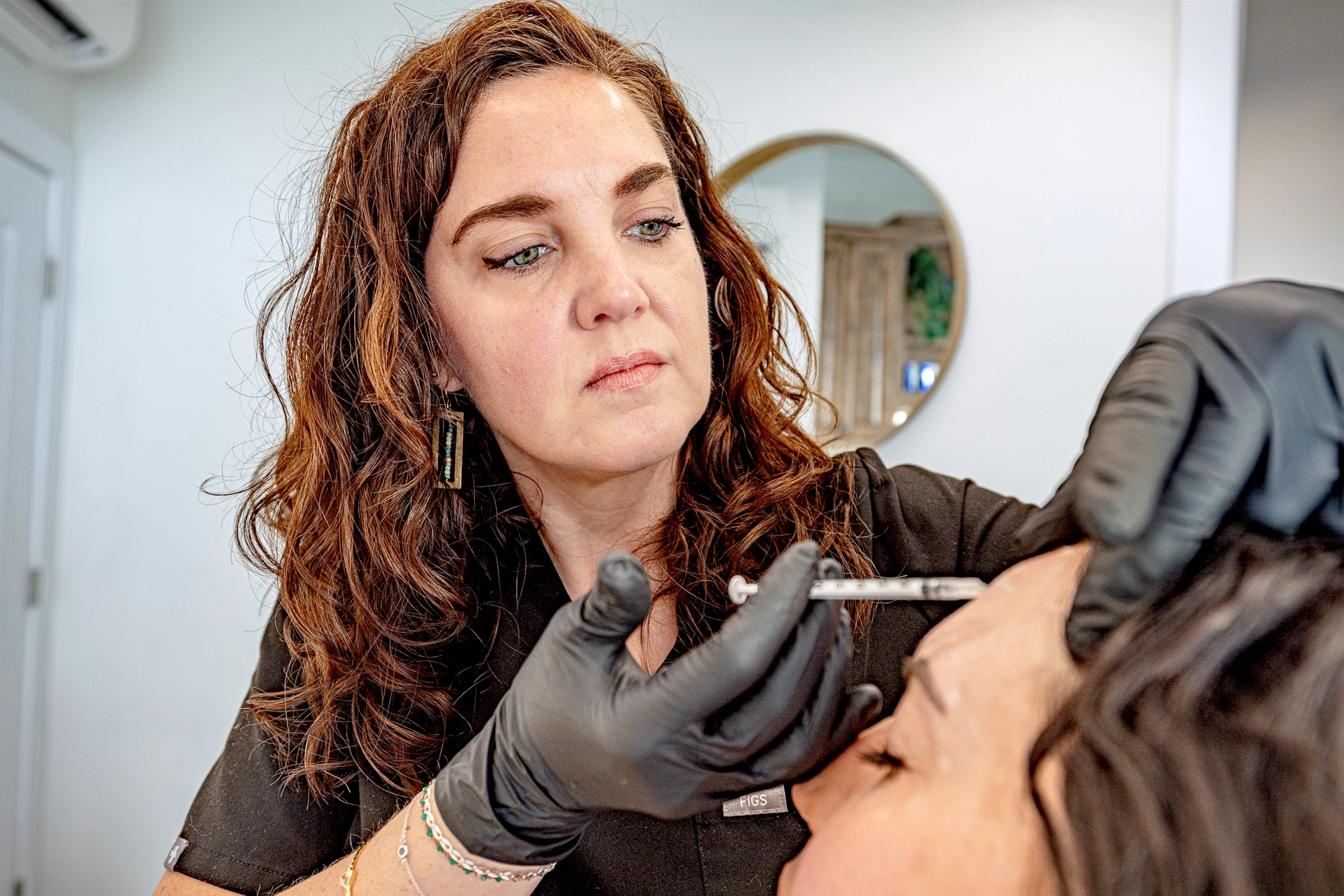 Melinda consulting with a patient before an aesthetic procedure.