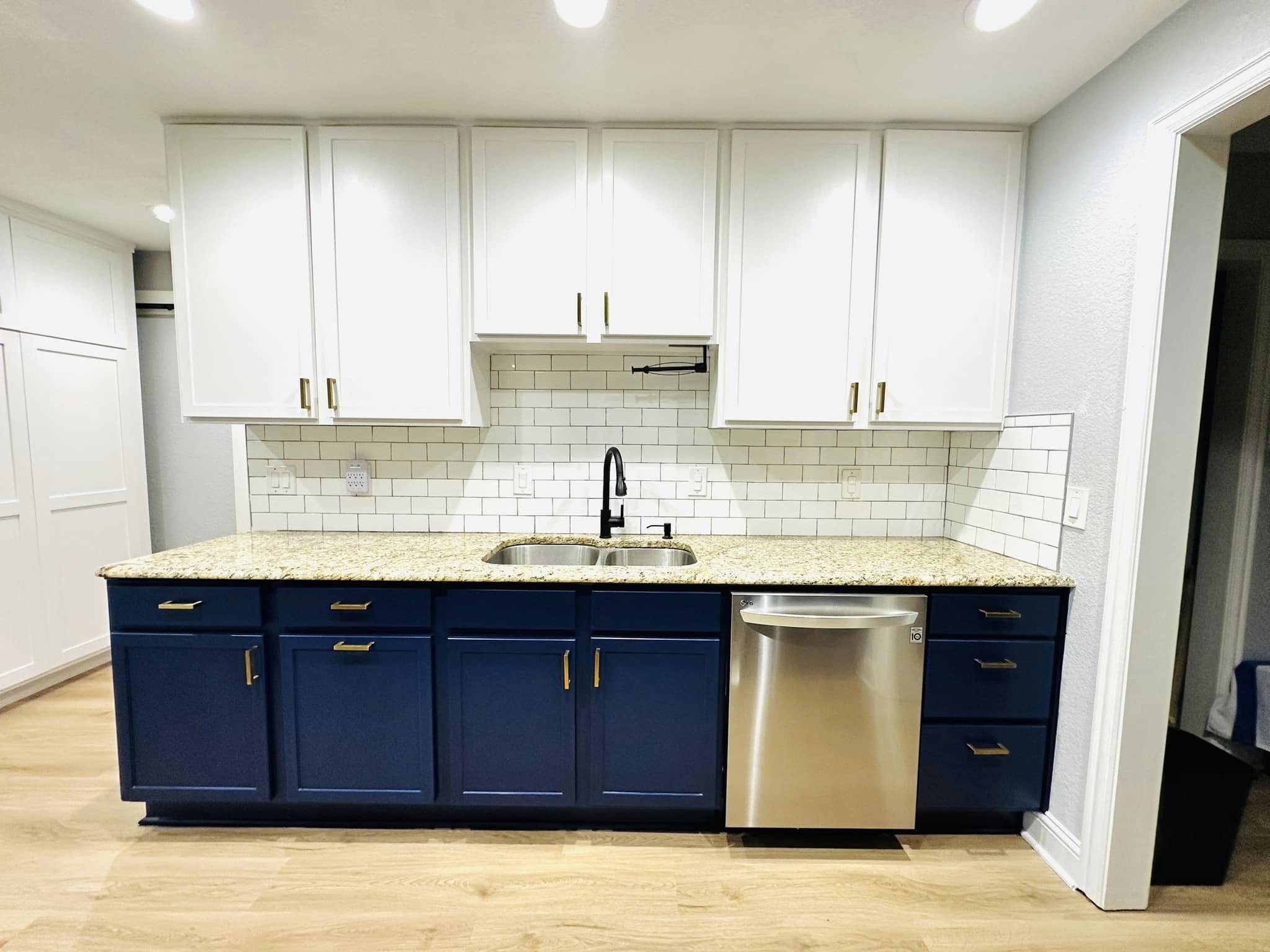 Kitchen remodeled in Deep Ellum, Texas featuring custom blue cabinetry, quartz countertops, modern backsplash, and improved kitchen storage solutions.