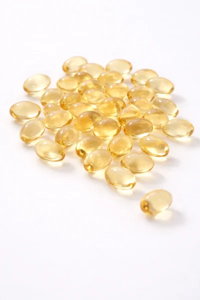 Vitamin D capsules on a white background
