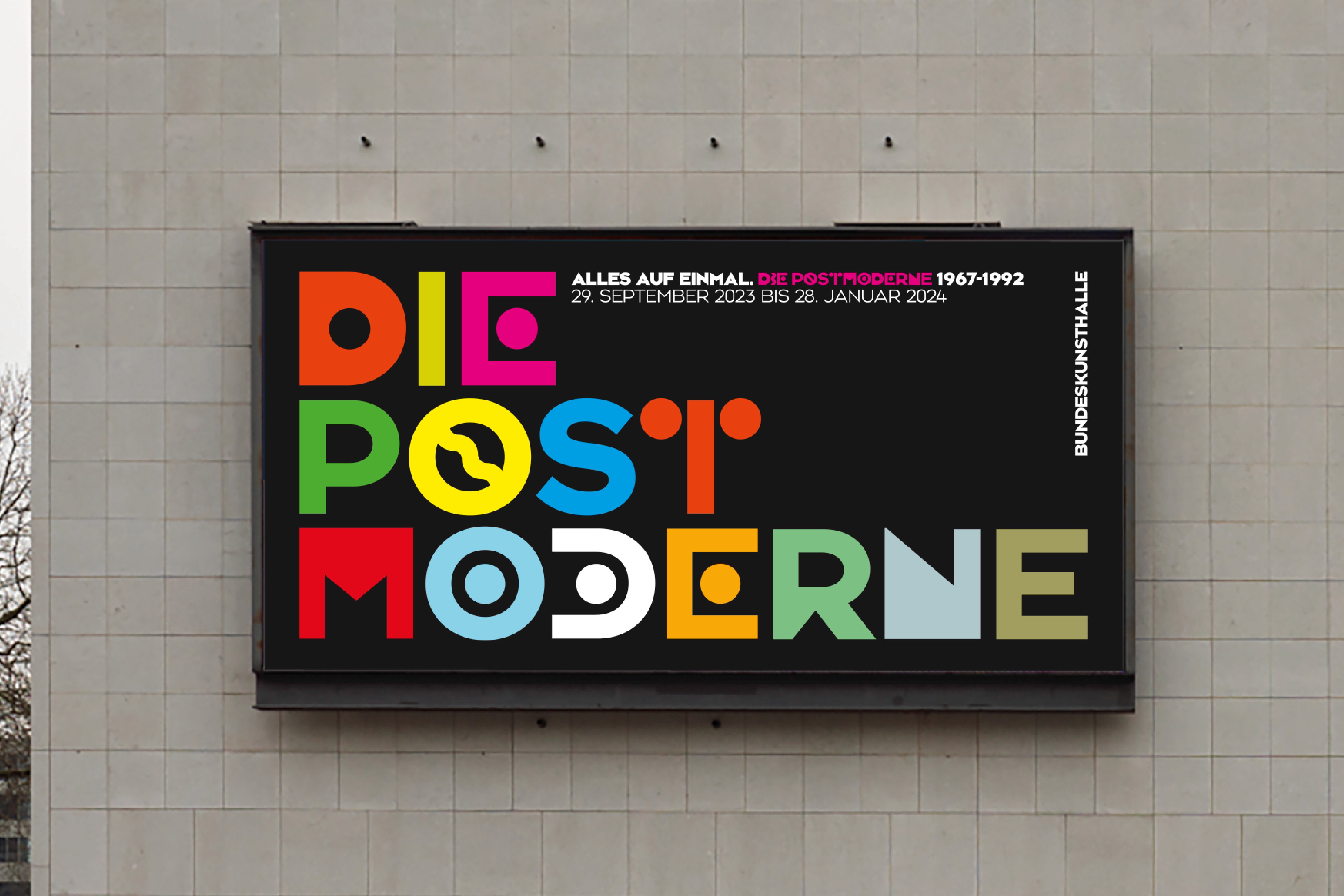 A decorative sign with colorful letters spelling "DIE POST MODERNE" against a dark background.