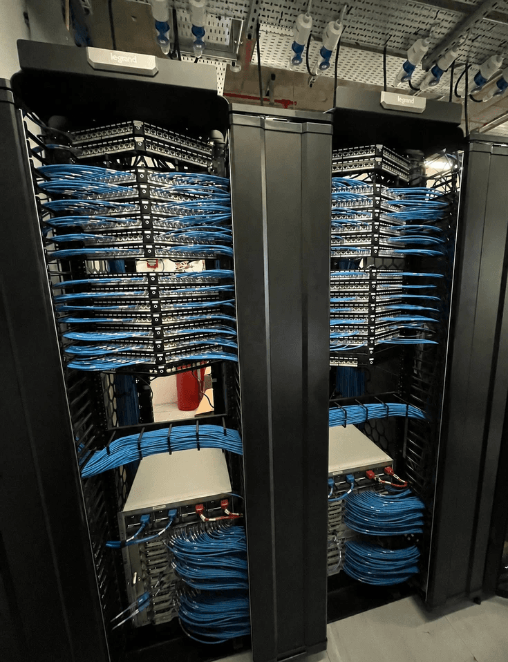 Organised blue network cabling installed across data centre server racks