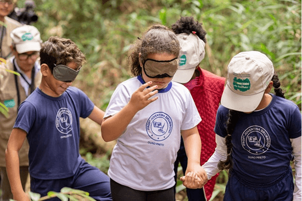 brown wooden lounger near body of water
