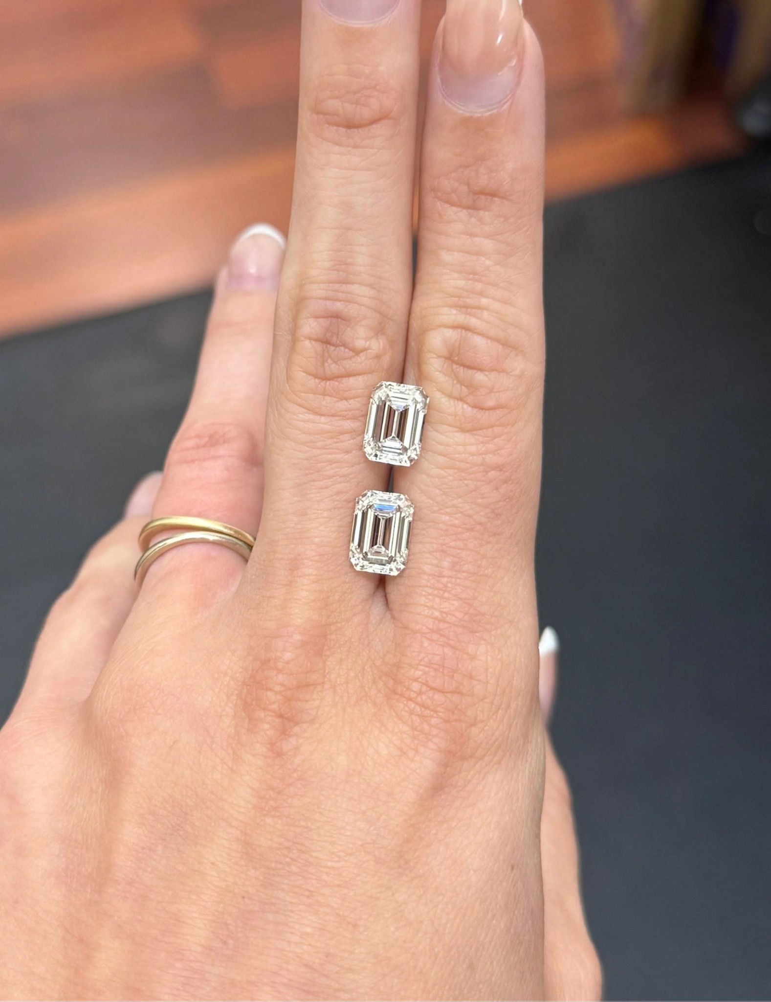 A Pair of emerald cut lab-grown diamond with long step facets.