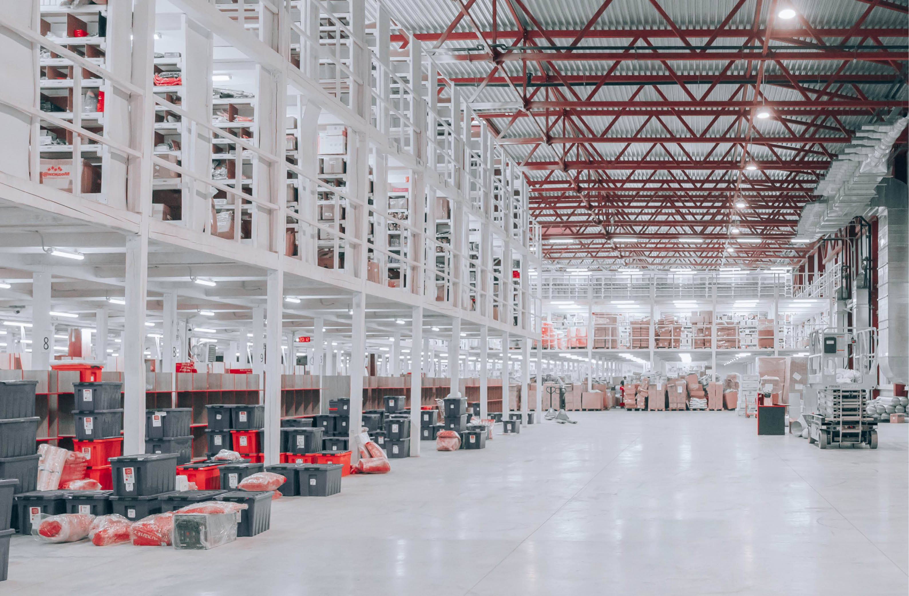 Spacious modern warehouse filled with organized boxes and shelving for efficient inventory management.
