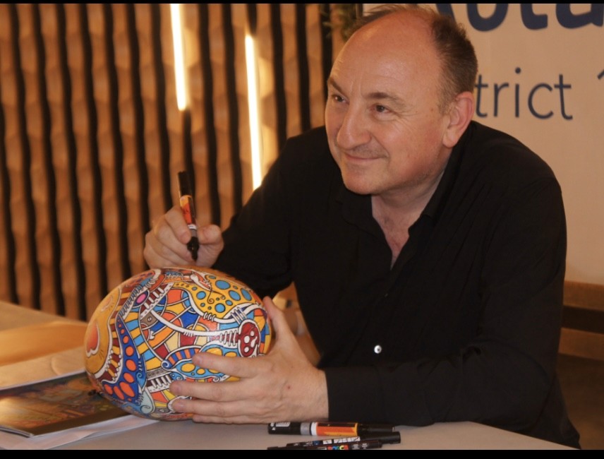 a blurry photo of a person standing in front of a wall