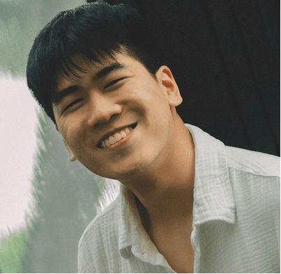 Smiling man in white shirt and tan pants