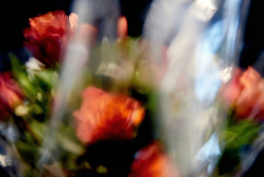 A fast black sports car races down the highway.