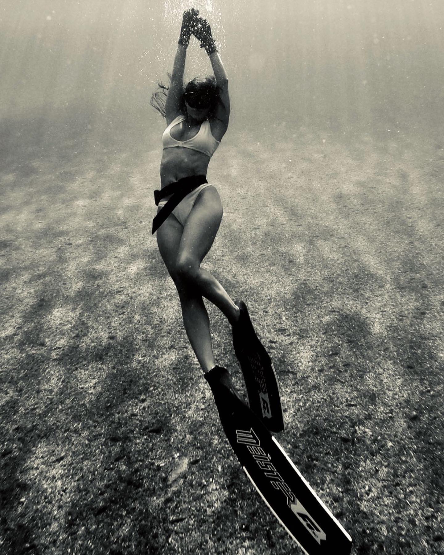 woman meister diver swimming underwater