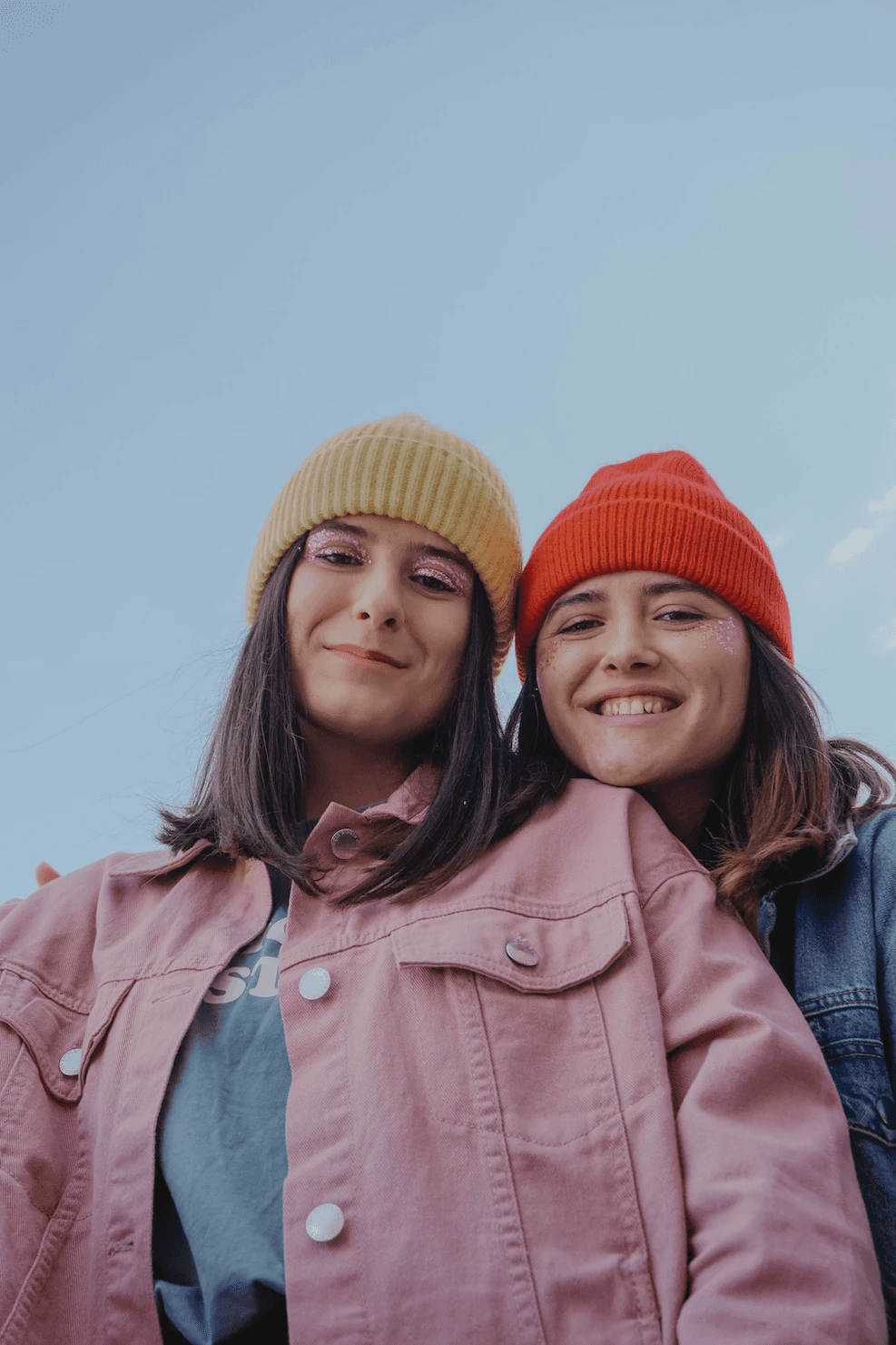 Two women wearing beanies