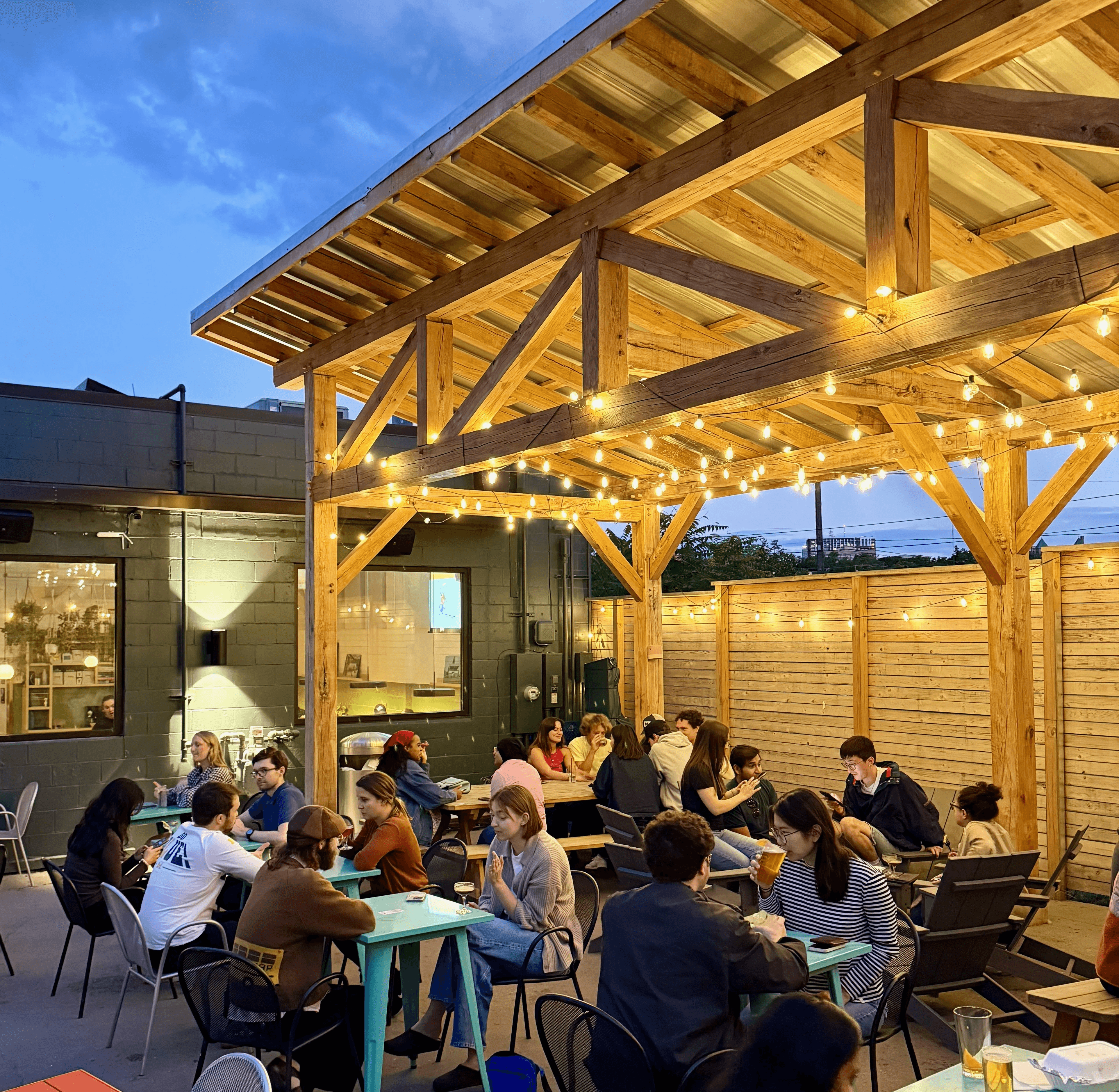Outdoor patio covered by lit up timber framer pergola