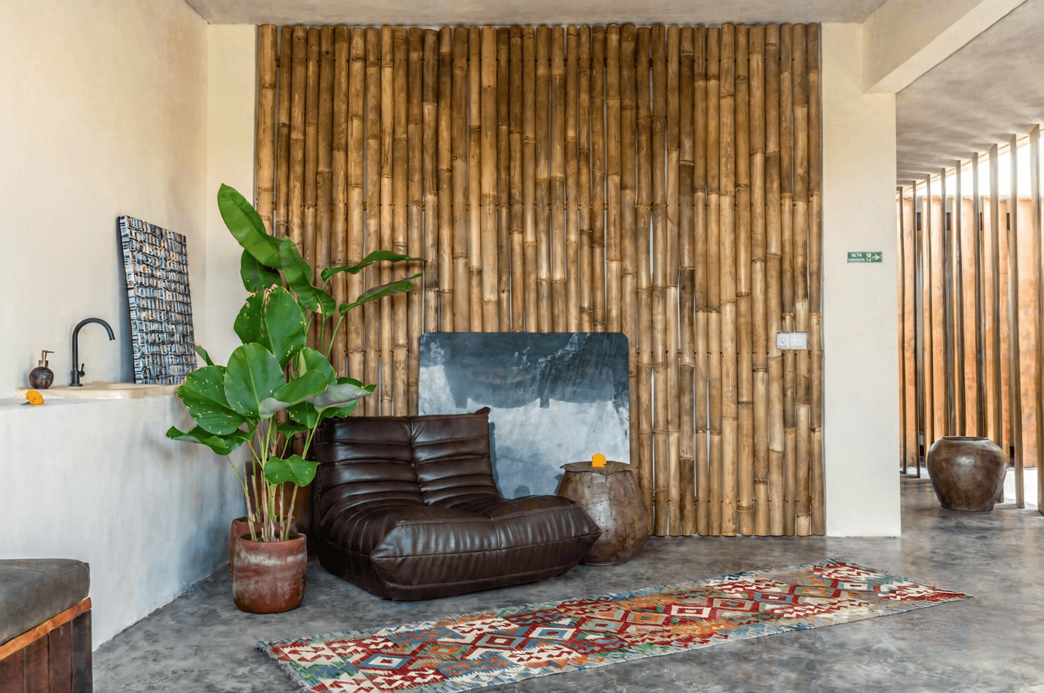 Unique bamboo wall interior in Kerobokan. Expert real estate agent services for authentic Balinese property designs.