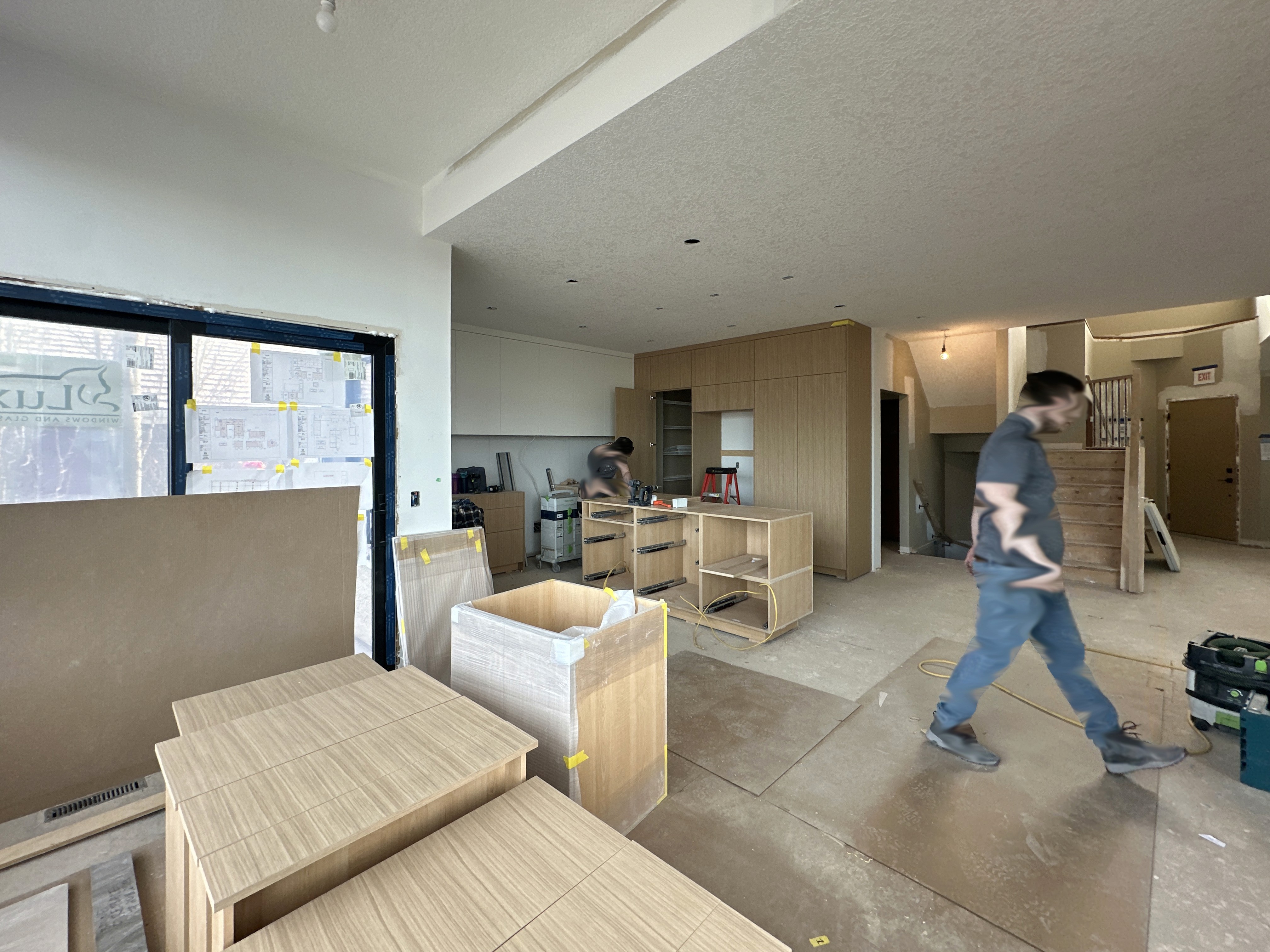 Image of KHD Homes construction team working on kitchen layout design and renovations with custom cabinetry and furniture.