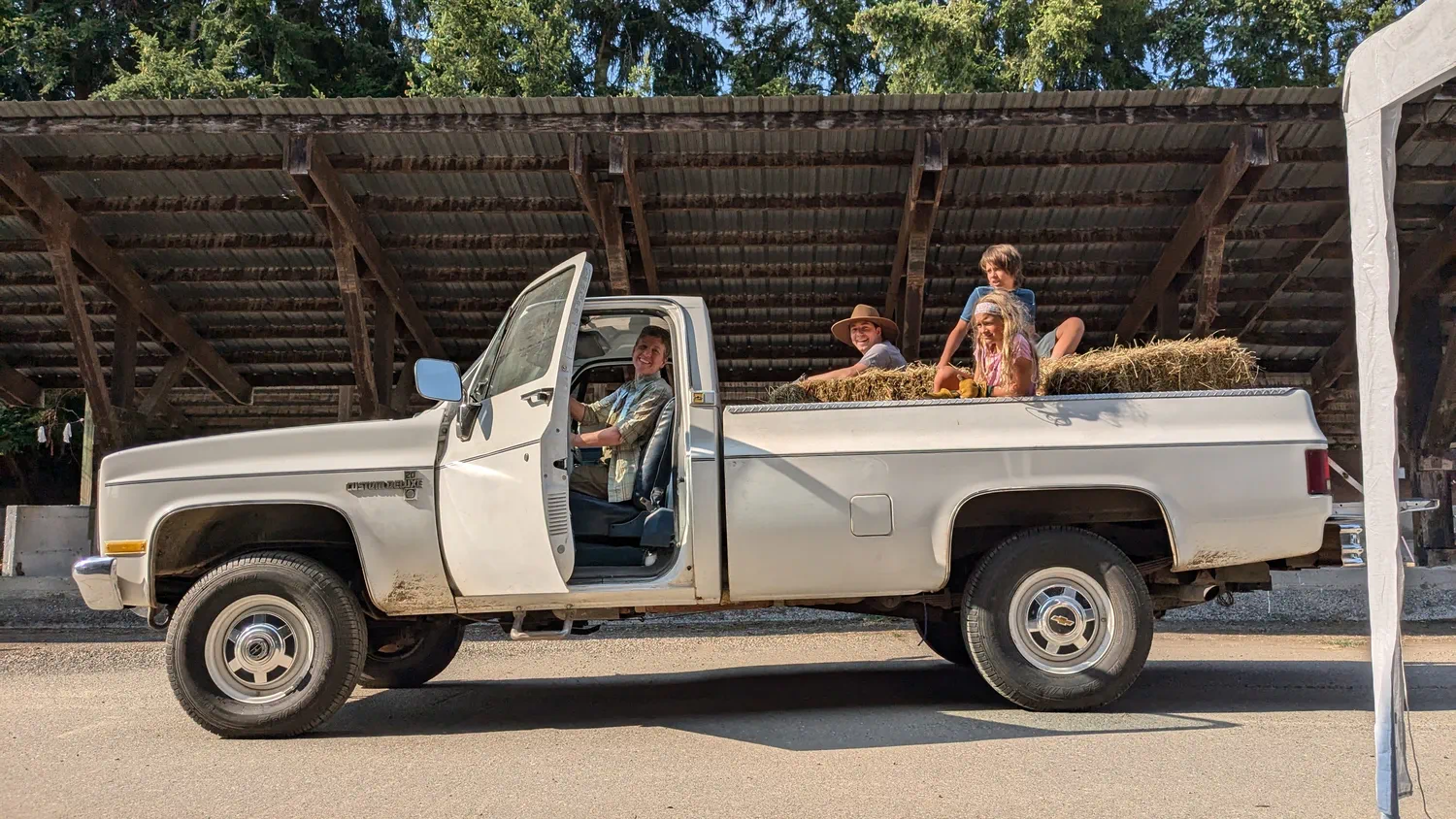 Residents riding together in a farm vehicle during a shared work day.