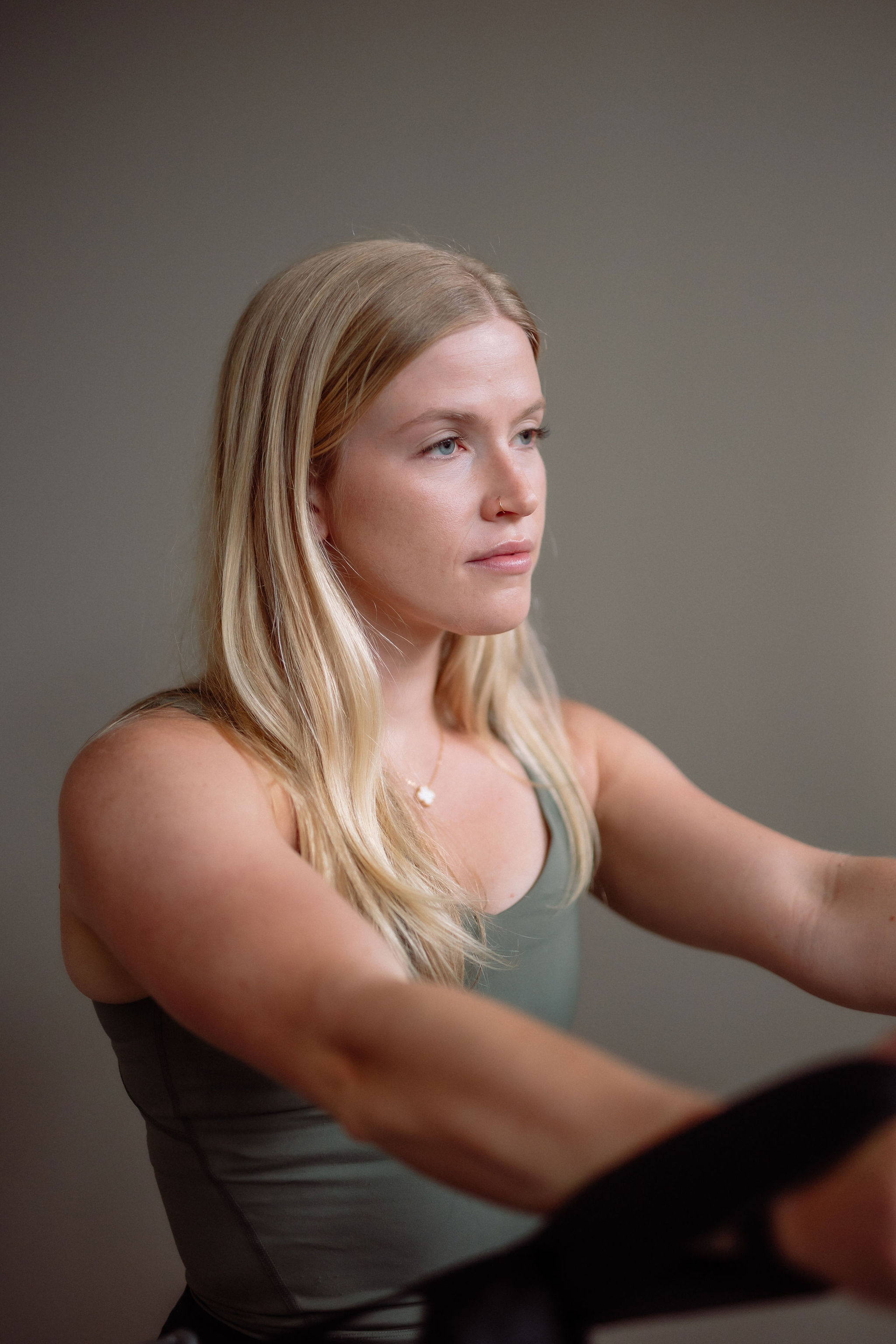 Black cosmetic product bottle against a dark background
