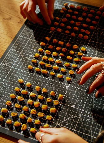     Hands arranging plant-based chips