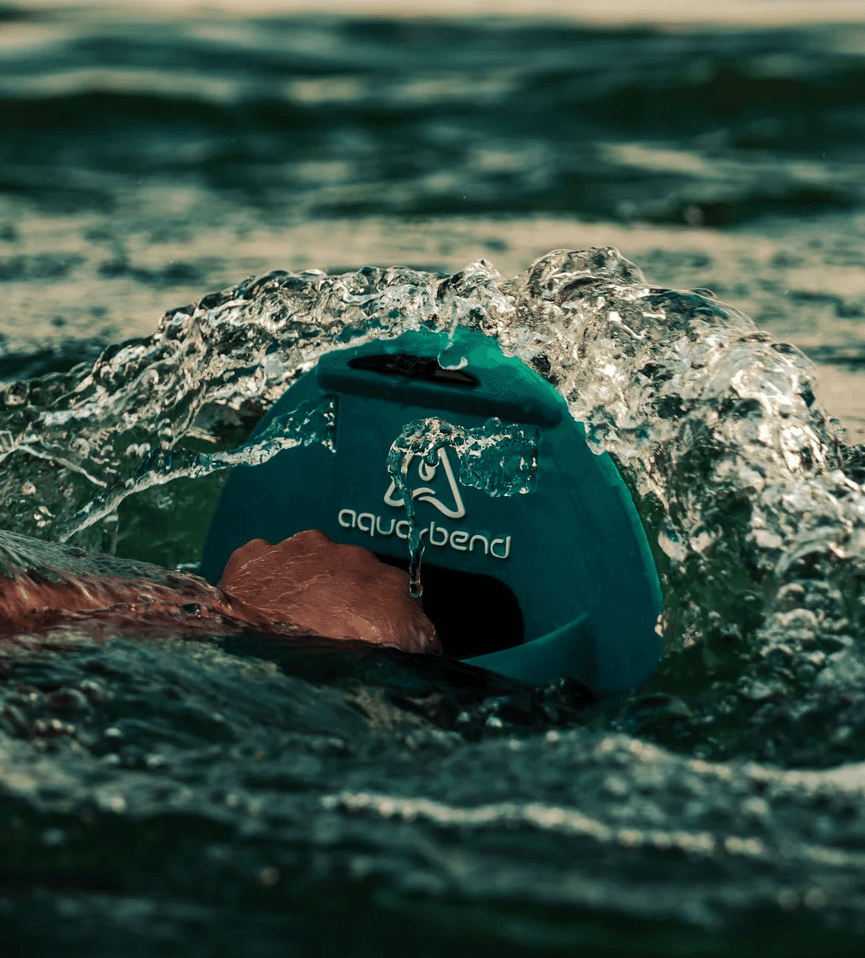 Close-up of hand gripping Aqua-Bend disc during chest press, water rippling over the disc from resistance