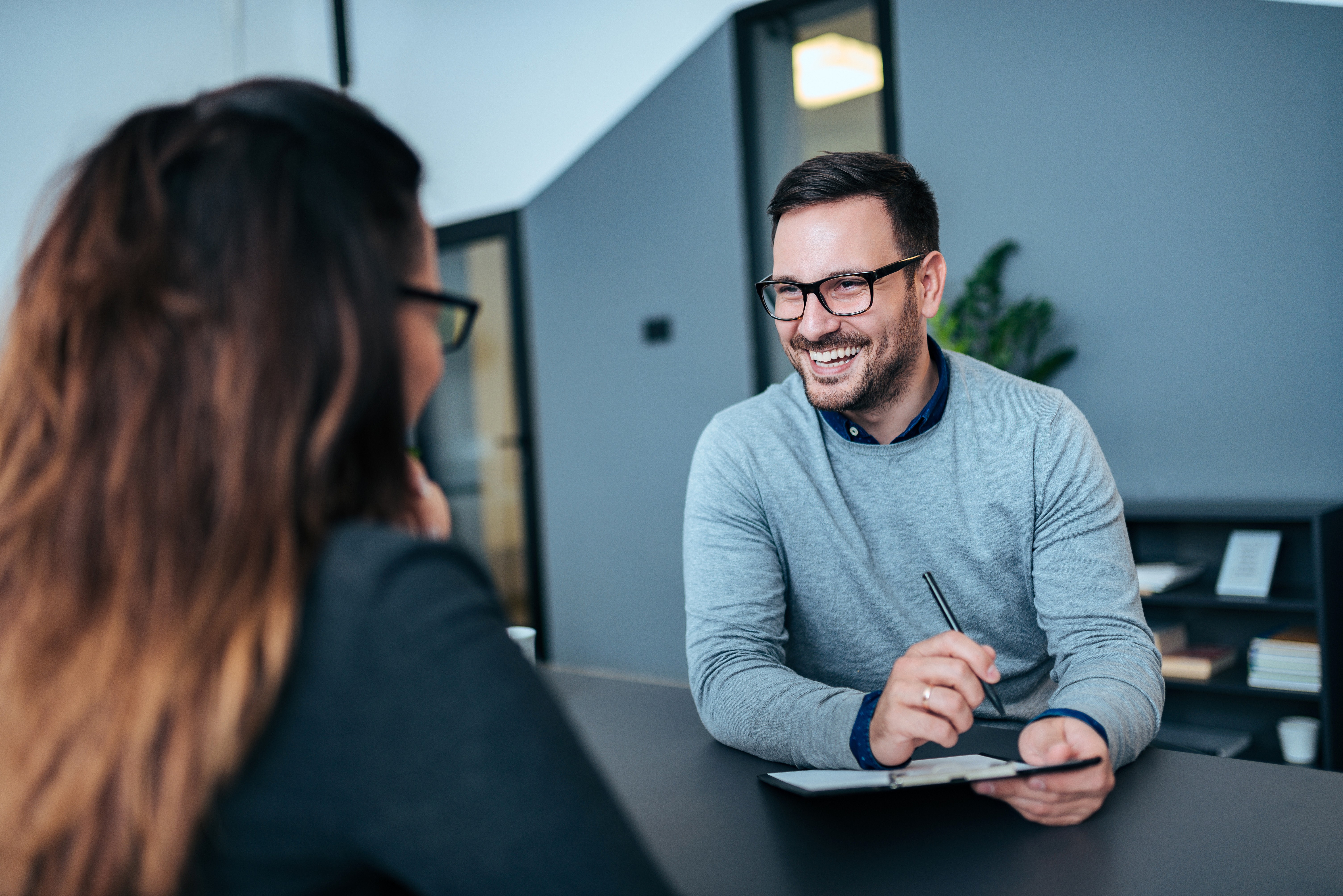 A man vetting a potential job candidate.