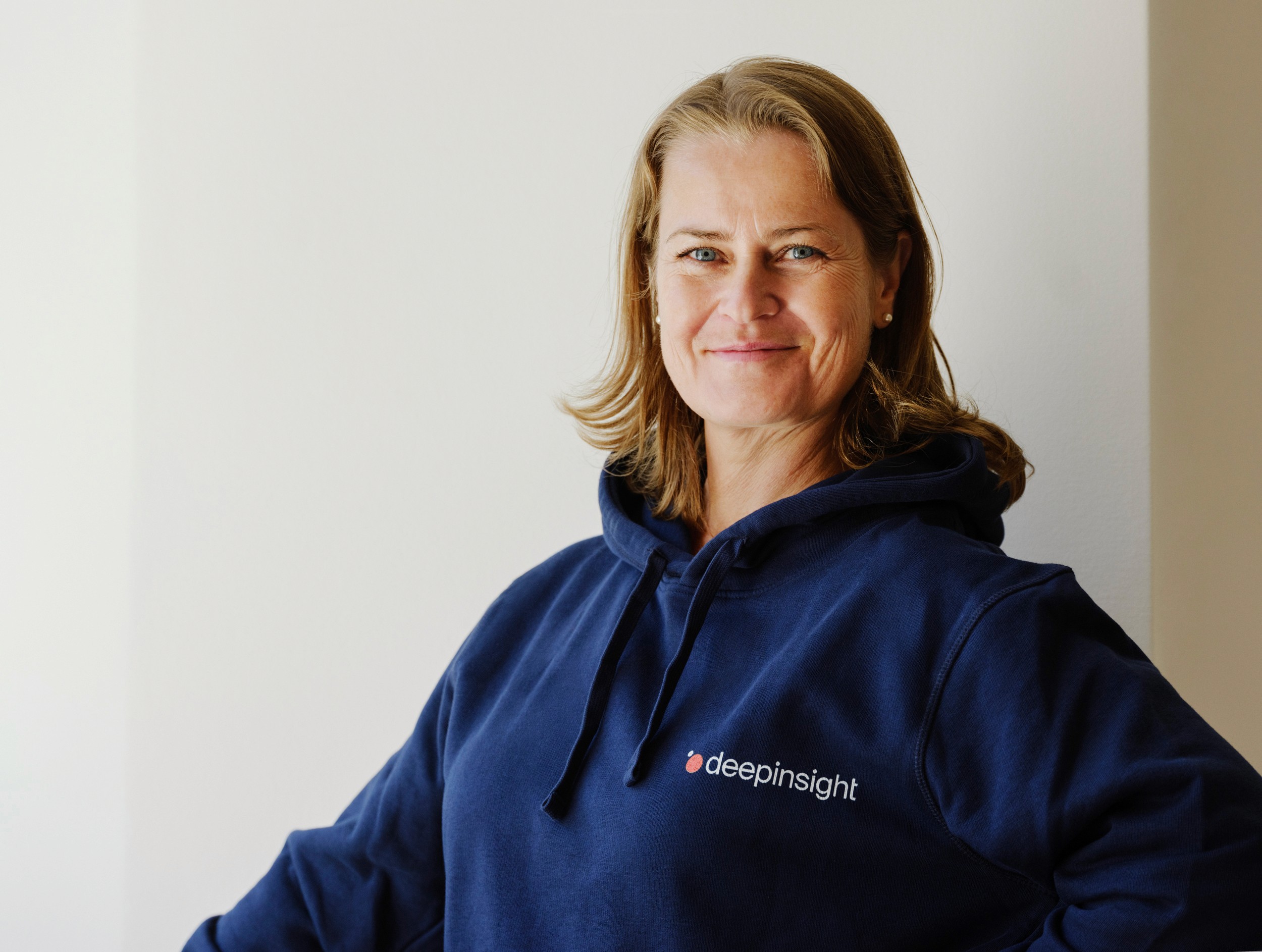 Female with Deepinsight hoodie smiling