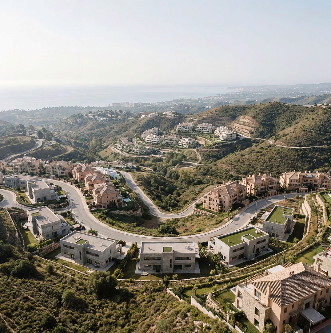 Aerial view of Marbella hills with luxury villas and coastline in the distance