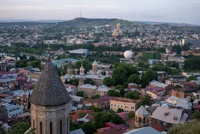 Panoramic view of Tbilisi with historic rooftops and modern landmarks