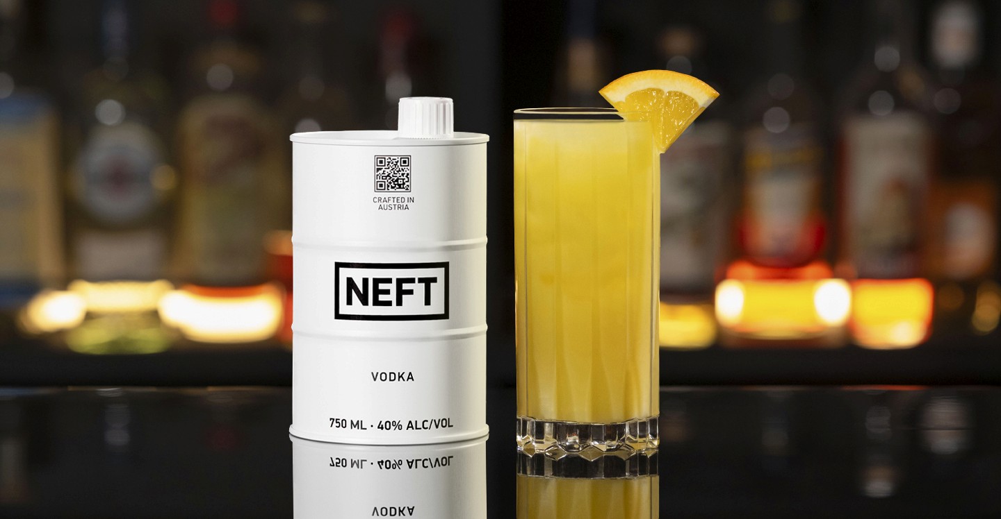 A NEFT Barrel and a glass of Game Day on a bar counter.
