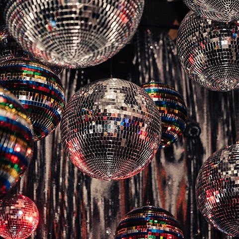 Mirrored disco balls hanging in a cluster, representing the metal element