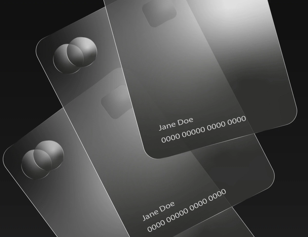 Three transparent credit cards are stacked.
