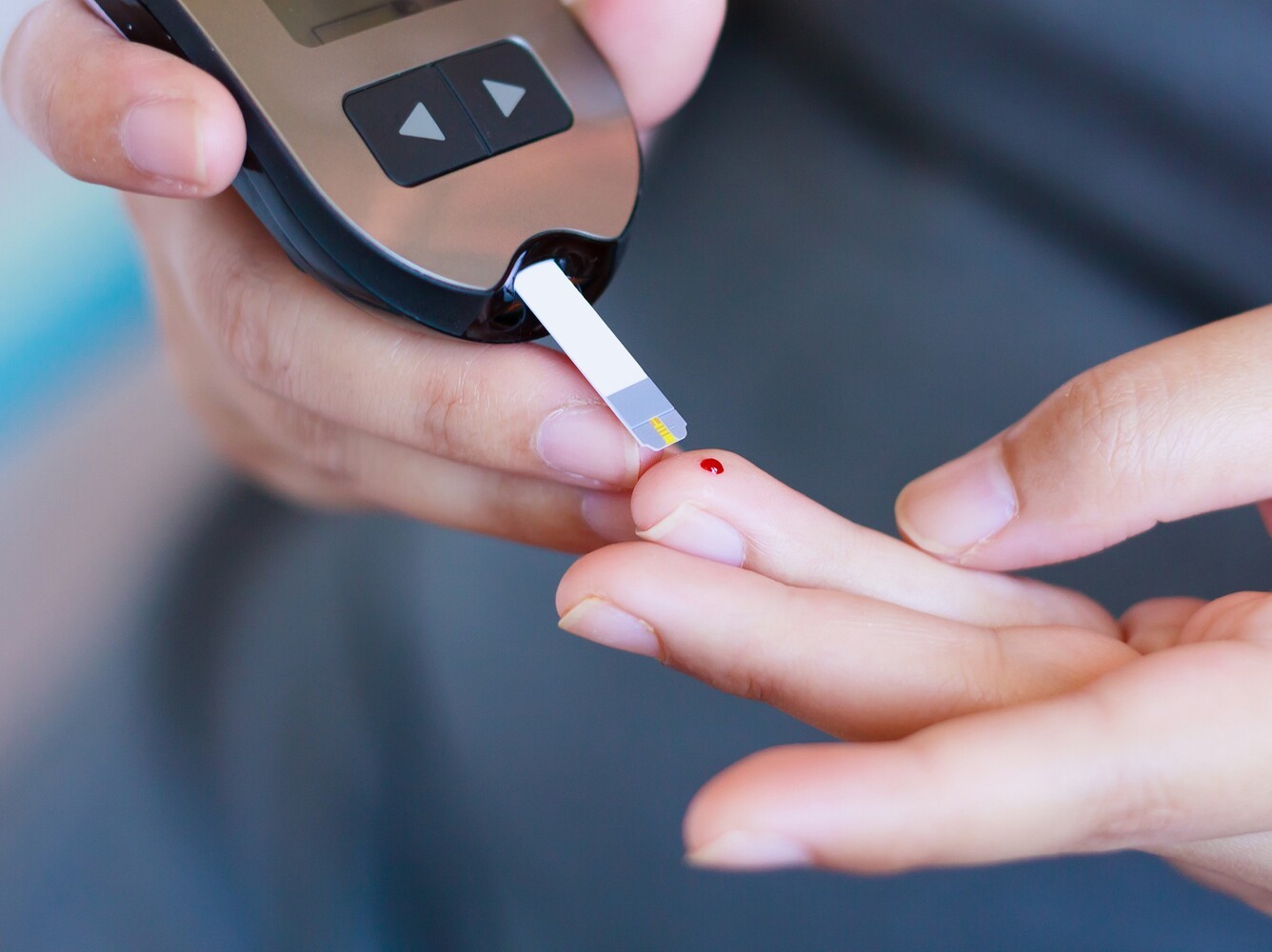 person checking their blood sugar level while exploring weight loss drug options