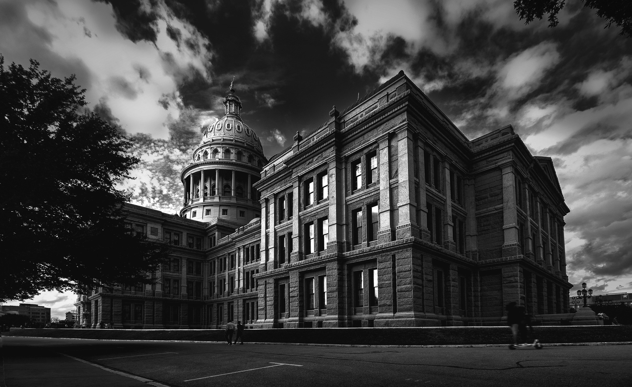 A person standing inside an icy blue cave near an opening
