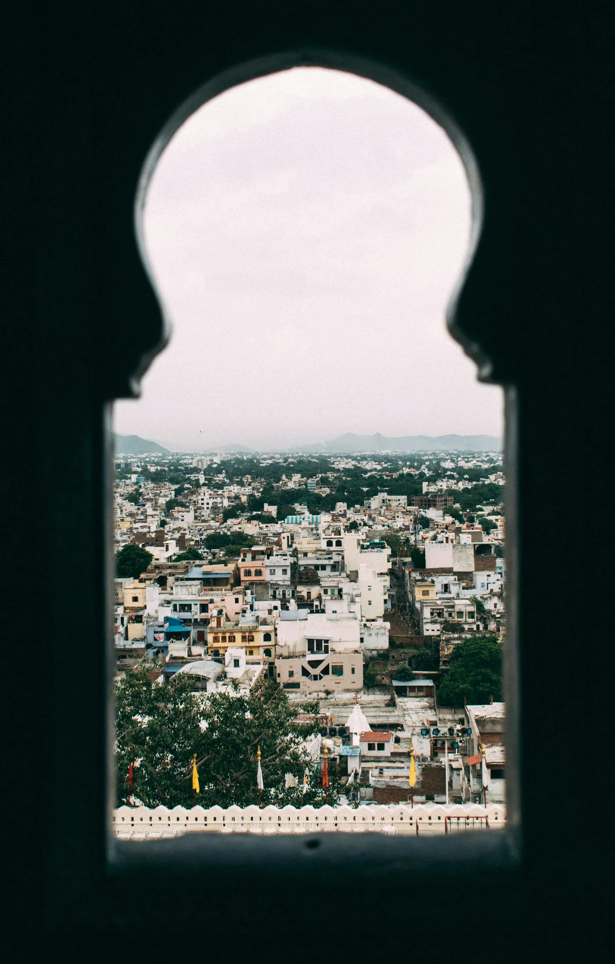 red train travelling near body of water
