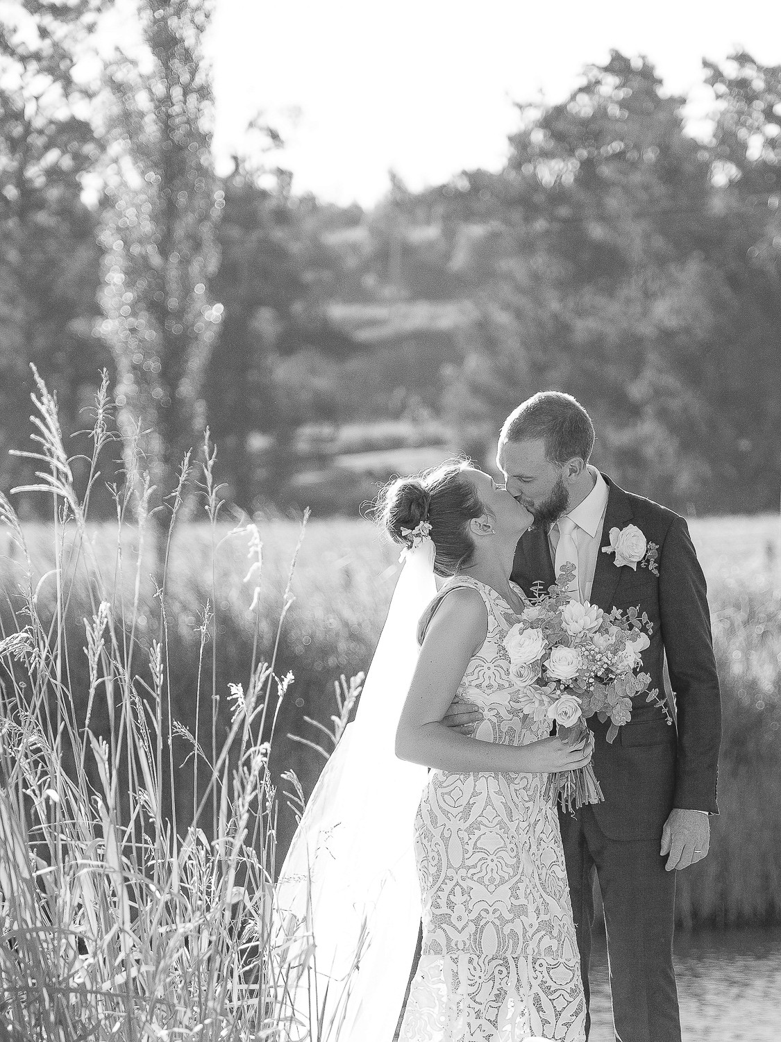 Portrait of wedding photographer – woman laughing outdoors, black and white photo